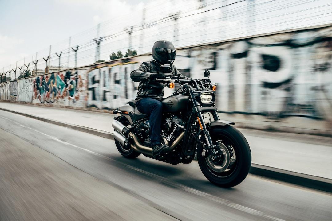 A motorcyclist riding down the street.